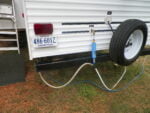 Fresh water hook ups, sewer solution, and filter on rear of camper
